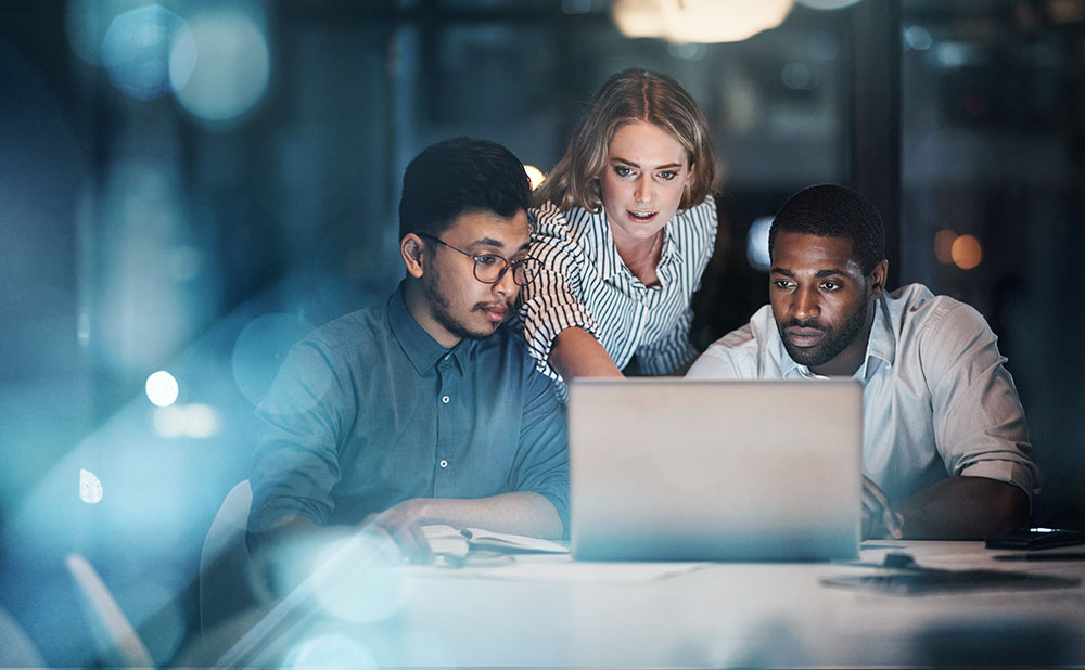 Three young people working together on a laptop