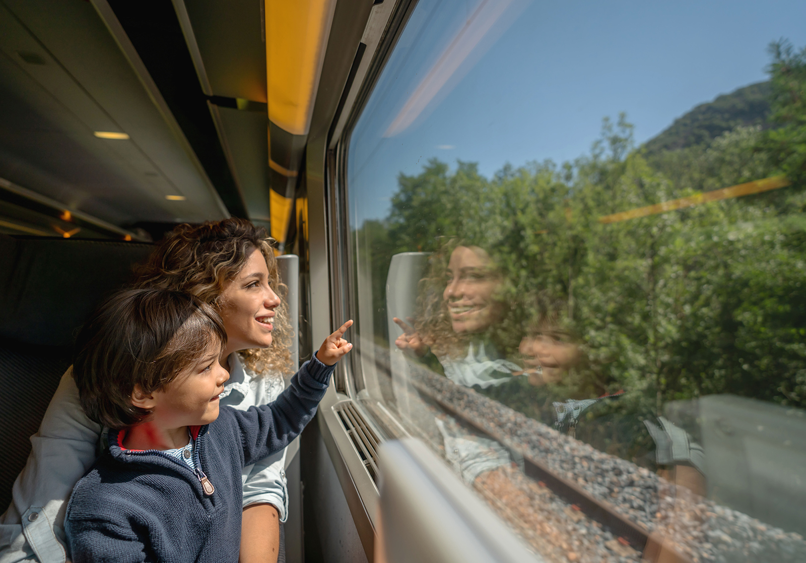 Mother and child looking out train window