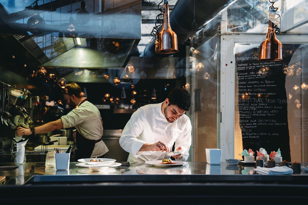 Chefs preparing meals in kitchen